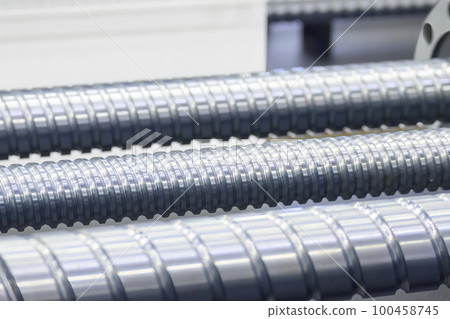 Closeup scene the spare parts lead ball screw parts in the light blue scene. Closeup scene the spare parts lead ball screw parts in the light blue scene. 100458745