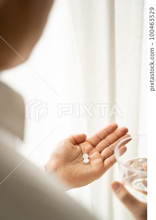 Businessman drinking medicine 100463529