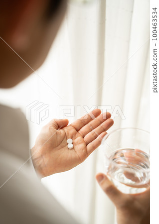 Businessman drinking medicine 100463534
