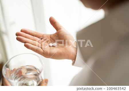 Businessman drinking medicine Businessman drinking medicine 100463542
