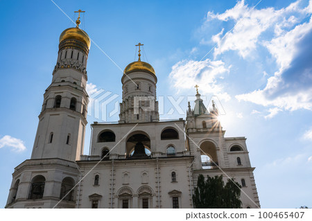 Ivan the Great Bell Tower, with Assumption Belfry on the right in Moscow Kremlin. Blue sky background with sunbeams 100465407