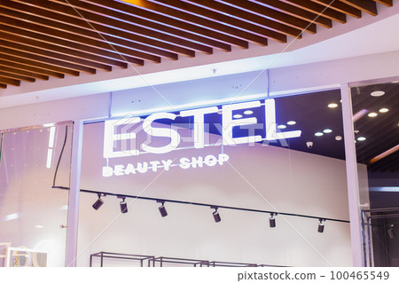 estel beauty shop neon light store sign close-up. entrance of perfumery and cosmetics shop. 100465549