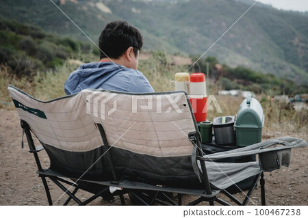Man enjoying picnic in love chair Man enjoying picnic in love chair 100467238