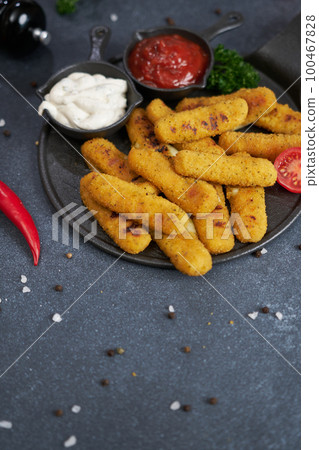 Cooked Mozzarella Cheese sticks with tartar and red tomato sauces on a plate Cooked Mozzarella Cheese sticks with tartar and red tomato sauces on a plate 100467828