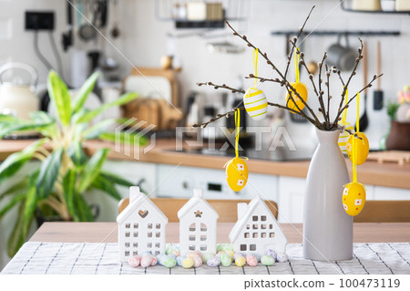 Key to house of cozy home with Easter decor with rabbit and eggs on table of kitchen. Building, design, project, moving to new house, mortgage, insurance, rent and purchase real estate Key to house of cozy home with Easter decor with rabbit and eggs on table of kitchen. Building, design, project, moving to new house, mortgage, insurance, rent and purchase real estate 100473119