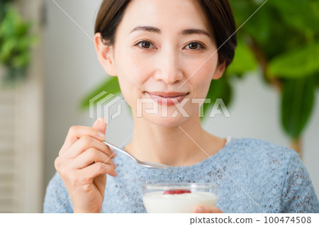 Young woman eating yogurt Food and drink image 100474508