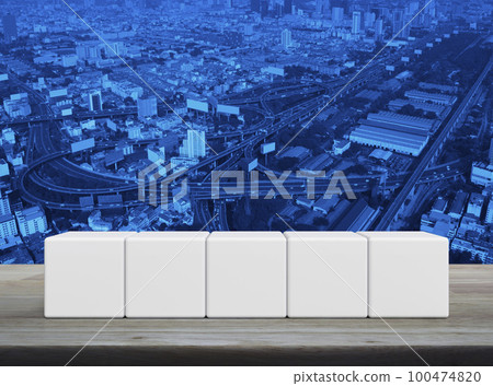 Five white block cubes on wooden table 100474820