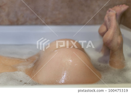 Female buttocks closeup in bath Female buttocks closeup in bath 100475319