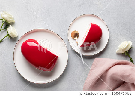red heart mousse cake on gray background with white roses. red heart mousse cake on gray background with white roses. 100475792