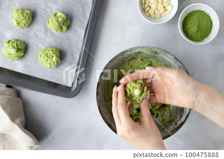 female hands making matcha green tea cookie female hands making matcha green tea cookie 100475888
