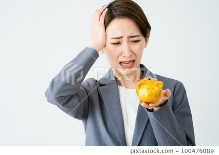 A young woman holding a piggy bank Business image 100476089