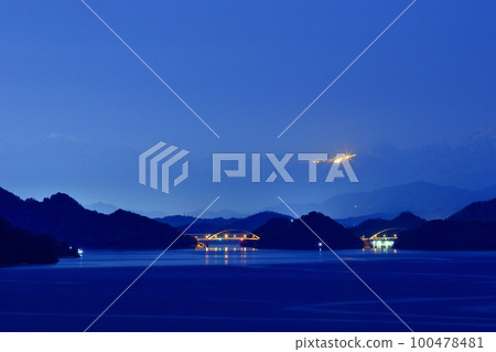 The Shikoku Mountains rising beyond the Seto Inland Sea at night 100478481