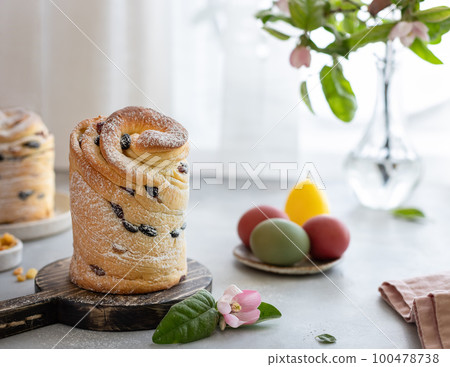 Easter composition with Cruffin Kulich, painted eggs, blossoming apple branch 100478738