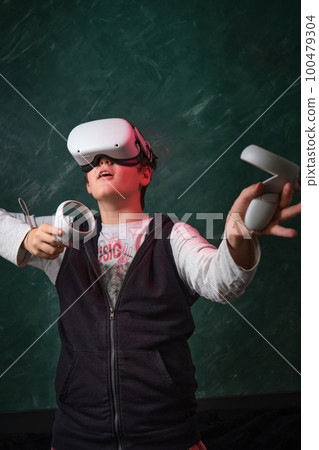 a boy playing with VR headset 100479304