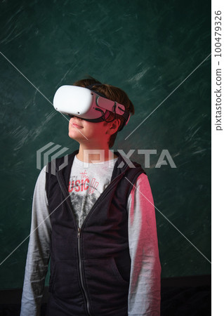 a boy playing with VR headset a boy playing with VR headset 100479326