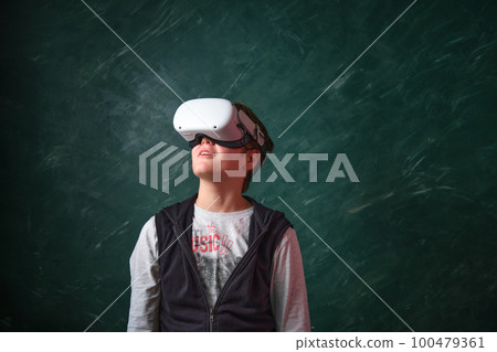 a boy playing with VR headset 100479361