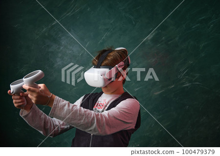 a boy playing with VR headset 100479379