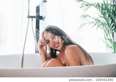 Beautiful young woman have free time at home in the bath 100481890