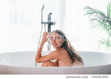 Beautiful young woman have free time at home in the bath 100481893