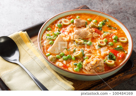 Asopao de Pollo this comforting Puerto Rican chicken and rice gumbo dish is loved throughout the Caribbean closeup on the bowl. Horizontal Asopao de Pollo this comforting Puerto Rican chicken and rice gumbo dish is loved throughout the Caribbean closeup on the bowl. Horizontal 100484169