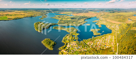 Lyepyel District, Lepel Lake, Beloozerny District, Vitebsk Region. Aerial View Of Residential Area With Houses In Countryside. Top View Of Island Pension Lode From High Attitude In Autumn Sunny Day Lyepyel District, Lepel Lake, Beloozerny District, Vitebsk Region. Aerial View Of Residential Area With Houses In Countryside. Top View Of Island Pension Lode From High Attitude In Autumn Sunny Day 100484317