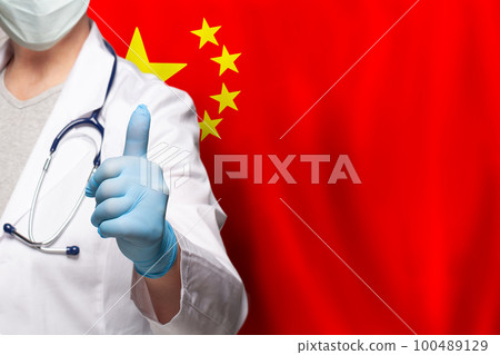 Chinese doctor's hand showing thumb up positive gesture on flag of China background Chinese doctor's hand showing thumb up positive gesture on flag of China background 100489129