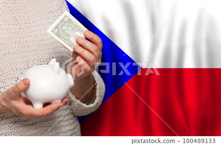 Czech woman with money bank on the background of Czech Republic flag. Dotations, pension fund 100489133