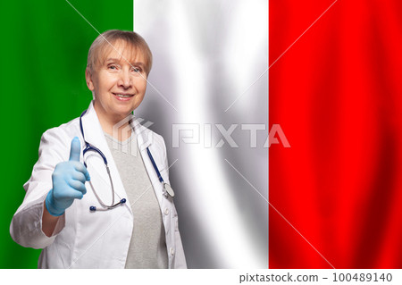 Italian smiling mature doctor woman holding stethoscope on flag of Italy background Italian smiling mature doctor woman holding stethoscope on flag of Italy background 100489140