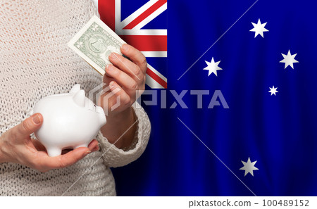 Australian woman with money bank on the background of Australia flag. Dotations, pension fund 100489152