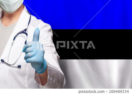 Estonian doctor's hand showing thumb up positive gesture on flag of Estonia background 100489154