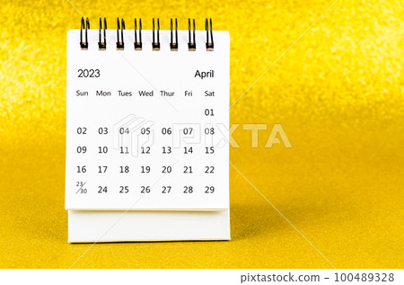 The April 2023 Monthly desk calendar for 2023 year on golden color background. 100489328