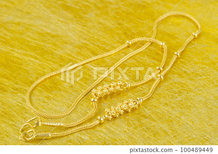 The Gold necklace on gold color background. 100489449