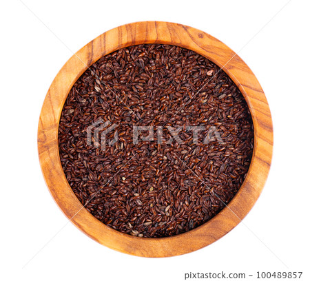 Psyllium seeds in wooden bowl, isolated on white background. Plantain. Plantago psyllium. Top view. Psyllium seeds in wooden bowl, isolated on white background. Plantain. Plantago psyllium. Top view. 100489857