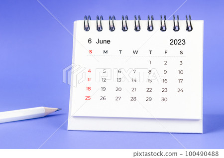 The June 2023 Monthly desk calendar for 2023 year with pencil on purple background. 100490488