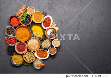 Various spices in bowls on stone table Various spices in bowls on stone table 100491162