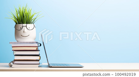 Laptop and stack of notepads Laptop and stack of notepads 100492019