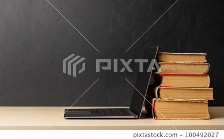 Laptop and stack of notepads Laptop and stack of notepads 100492027