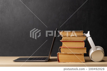 Laptop and stack of books Laptop and stack of books 100492028