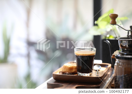 Coffee glass cup and coffee utensil and coffee grinder on white table 100492177