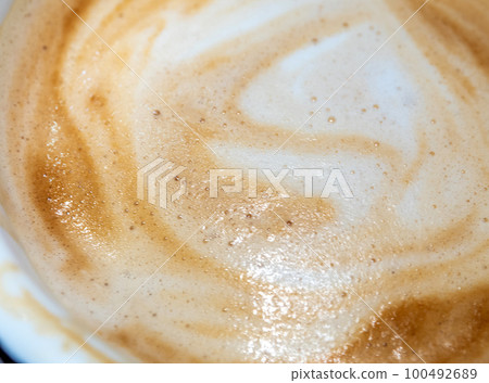 Texture surface of soft and delicate milk froth in a cup of coffee 100492689