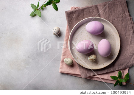 lilac colorful easter eggs in ceramic plate 100493954
