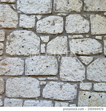 Sturdy yellow and beige cut stone wall, seamless lined up Sturdy yellow and beige cut stone wall, seamless lined up 100494474