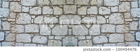 Sturdy yellow and beige cut stone wall, seamless lined up Sturdy yellow and beige cut stone wall, seamless lined up 100494476