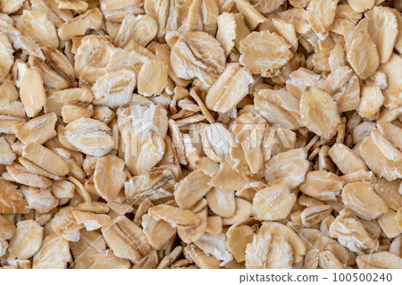 Rolled oat, oat flakes background, macro, top view. 100500240