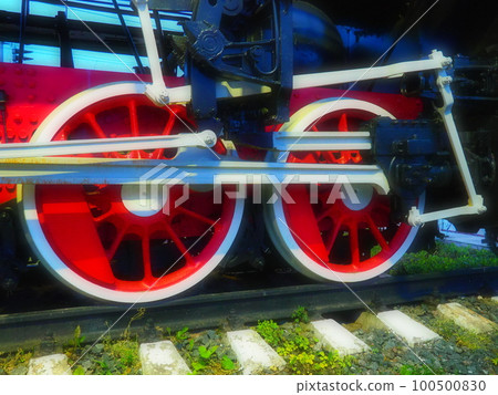 Retro vintage wheels of a locomotive or train close up. Red large heavy metal wheels with piston guiding mechanisms. Locomotive of the 19th - 20th centuries with a steam engine. Bright vivid photo Retro vintage wheels of a locomotive or train close up. Red large heavy metal wheels with piston guiding mechanisms. Locomotive of the 19th - 20th centuries with a steam engine. Bright vivid photo 100500830