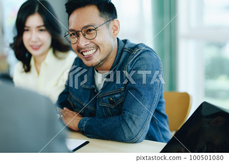 Guarantee Insurance Sign a contract, couple a smiling couple is signing a contract to invest in real estate with the Mortgage officer with the bank. Guarantee Insurance Sign a contract, couple a smiling couple is signing a contract to invest in real estate with the Mortgage officer with the bank. 100501080