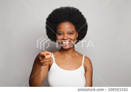 Happy attractive woman pointing finger at camera on white background Happy attractive woman pointing finger at camera on white background 100501592