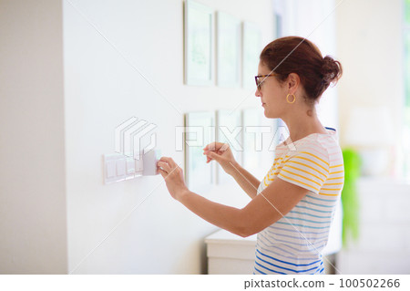Woman adjusting thermostat. Central heating. Woman adjusting thermostat. Central heating. 100502266