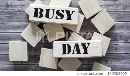text on busy day blocks and wooden background text on busy day blocks and wooden background 100502605