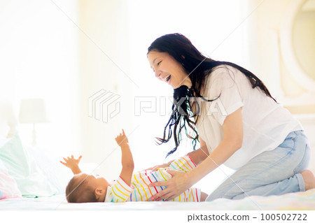 Baby and mother at home. Mom and child. 100502722